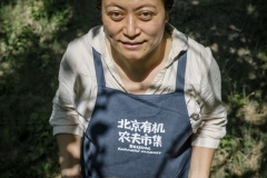 Chang Tianle, who runs the Beijing Farmers' Market. She volunteers her time at the Tianfu Garden Farm (God's Grace Garden) to help pick ripe organic cherries.