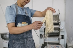 Zhu Jinlan, from Fujian province. She moved to Beijing in 2005, and ran a shop that sells wheat-based noodle, buns and pancakes. She joined Shared Harvest last year when her son and his wife (both work at Shared Harvest too) had a second child. She helps the couple take care of their kid, and opened up the noodle workshop in Shared Harvest.