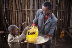 Antigegn Wunetu 30 and his wife, Mekle Wunete 27 with son (photographed with chickens) Adisu 7 and baby Simegn 1 yr 9months, beneficiaries of The Debre Yacob Watershed Learning Restoration Project in Bahir Dar, Ethiopia.

Antigen says,
“ I have just bought 24 chickens.
Before they started the project 8 years ago there was nothing growing here. Since they supported the community I can now grow vegetables, fruits, and chickens. We are benefiting so much, we can eat our produce and sell the leftovers, I get benefit from avocado, hops, mangos, hops, we didn’t know avocado before they brought it here. We used to have a small grass covered hut, now we have a big house. All my expenses are now covered.
Before I was thinking we would have to move because there was nothing here, now there is everything.
Have 4 children, and they are all involved in the farming. They love it. When they are not in school. They each have their jobs to help with on the farm and we are all enjoying being involved as a family.
I am so happy when I am doing the farming, but when I see the beauty of this now green area it makes me even happier.”