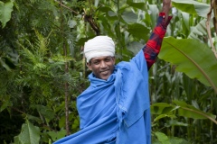 Watershed Committee Member Priest Kes Bale Eunetu 32, a beneficiary of The Debre Yacob Watershed Learning Restoration Project in Bahir Dar, Ethiopia.

Photographed by the gulley - he says. “The point of it is to save the land, by planting different types of plants, we can stop the landslides, and save the land, we have planted trees / grasses and we have harvested bio mass for animal fee from this area too. We are rehabilitating by cutting and feeding to animals.
It was hard work, before we started saving this land it was just a Valley and nothing was here. We, the whole community planted and worked to get it like this. The community is very happy. And that is assisted by the committee. We can cut the grass and feed our animals. Also, it helps us have a better climate.  We now have things like bananas, avocados, oranges, lemons, hops, coffee, all kinds of plants and trees.  I am so happy to be part of this.”