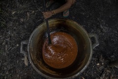 A farmer traditionally process sugar palm juice taken from a sugar palm tree into palm sugar at a forest in Sintang regency, West Kalimantan, Indonesia.