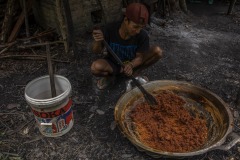A farmer traditionally process sugar palm juice taken from a sugar palm tree into palm sugar at a forest in Sintang regency, West Kalimantan, Indonesia.