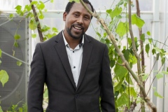 Dr Birhanu, age 39, Research Directorate Director at Gullele Botantical Gardens, Addis Ababa, Ethiopia. Photographed with Commiphora Monoiccao - critically endangered - “every plant has its own importance, every one is ecologically important- inside this plant is an oil that is used to treat wounds.”
“My degree is biology, I studied in Bahir Dar - I used to go to swim in blue mile river, collecting wood, have a close relationship with nature - and my interest just grew as I studied - most people in Ethiopia are very passionate about plants - the old people love plants - plants are everything for us - food, medicine, household implements, farming implements, building, they are everything it is an agricultural country, not an industrialised country , they cut plants because they don’t have options.  We aim to preserve and protect and grow plants to sell in the nurseries for the communities”