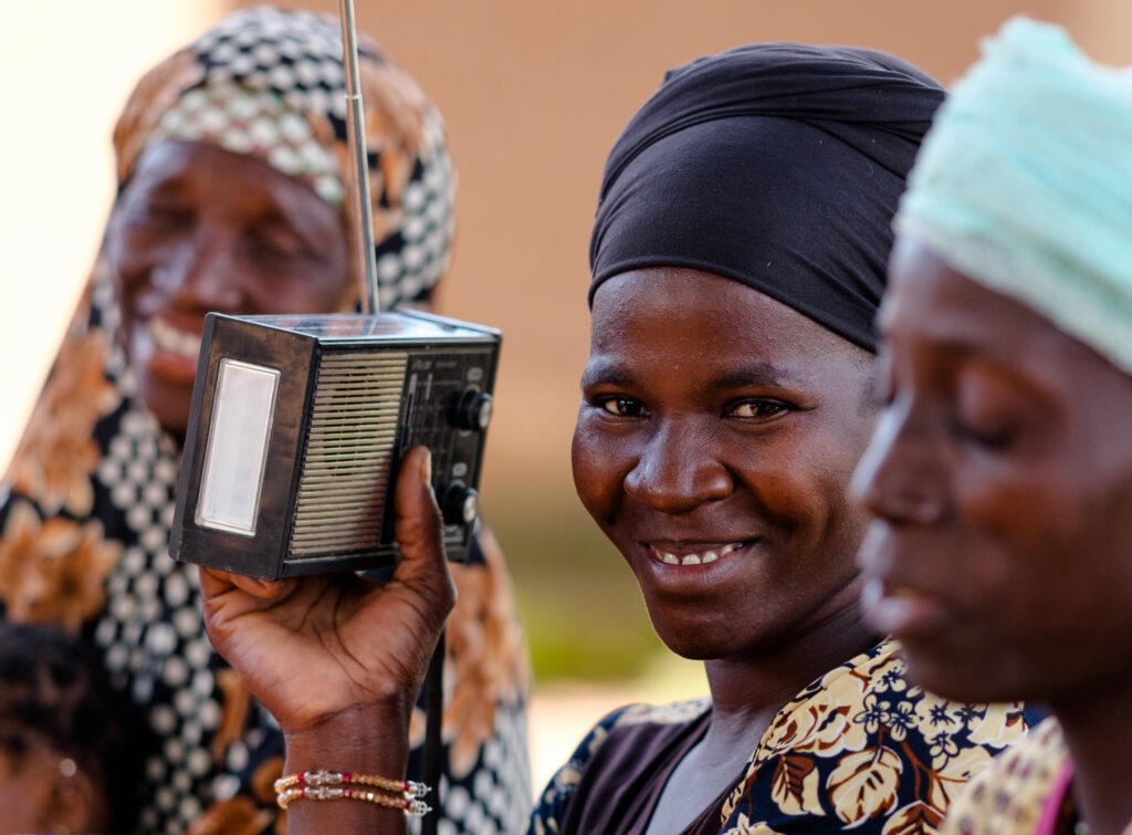 African woman listening to the radio